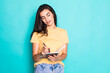 Pretty young beautiful woman standing, writing, take notes, holding textbook notebook organizer in hand and pen on turquoise background