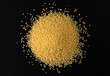 Heap of dry couscous isolated on black background