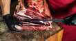 © Cavan Images - Butcher preparing and cutting meat