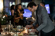 © Sean Locke Photography/Stocksy - NYE: Party Guests Enjoying A Meat And Cheese Platter