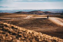 Lone Traveler Riding Through Desert