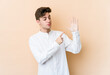 © Asier - Young caucasian man isolated on beige background smiling cheerful showing number five with fingers.