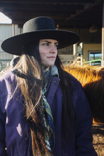 Cowgirl Standing With Horse