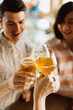 © CWP, LLC/Stocksy - Friends toasting craft beers during happy hour