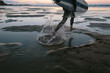 © denni/Stocksy - Person running to the ocean with his surfboard during sunrise