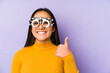Youn indian woman with optometry glasses smiling and raising thumb up