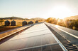 © Clare Seibel-Barnes/Austockphoto - Solar panels on a shed roof generating energy with sunlight lens flare