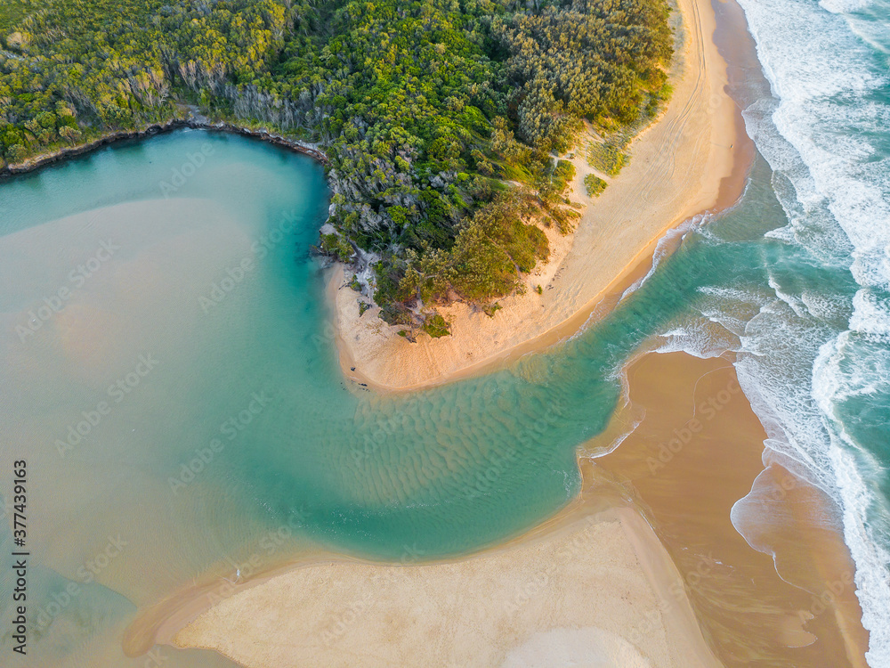 Aerial view of a river winding through a beach and out to sea Stock ...