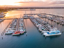 Looking Down On Rows Of Boats And Yachts At A Marina At Sunset