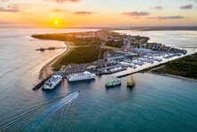 Aerial View Of A Ferry Terminal And Boats At A Marina At Sunset