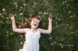 © Robert Lang/Austockphoto - Young girl lying on the grass, laughing