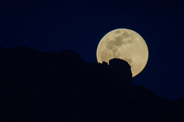 Wall Mural - full moon rising over mountains in the night