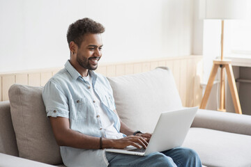 Handsome young man using laptop computer at home, Businessman working in his room, Home work or study, freelance, distance education, online communication concept