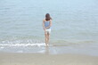 © Ekkarin - A woman walking into the sea