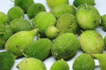 Fresh green colorful spiny gourd or teasel gourd vegetables on white background