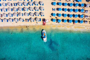 Wall Mural - aerial top down view to the umbrellas and the turquoise sea at the popular beach of ornos, mykonos i