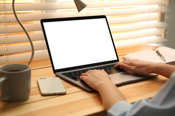 Aufkleber - Woman working with modern laptop at wooden table, closeup. Space for design