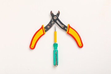 wire cutter and electricity tester on white background