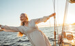 © Artem Varnitsin - Cheerful mature woman having fun on a private yacht at sunset
