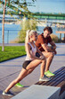 © astrosystem - Young adult sporty couple working out outdoors.