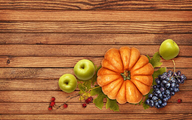 Wall Mural - autumn arrangement with pumpkin, grapes, apples, red berries and green leaves