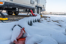 A Trailer, RV, Sewage Drain Hose Covered With Fresh Snow Connected To The City Hookup, Dump.