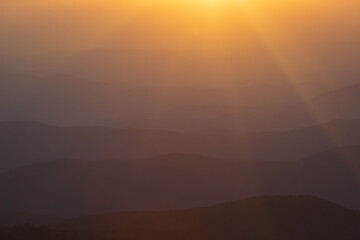 Layer of mountains and mist during sunset