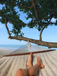 Relaxing in a hammock on a tropical beach in Krabi, Thailand