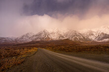 Mountain Road Through Snowy Peaks At Early Morning In Alaska
