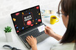 © Stanisic Vladimir - Black friday shopping online concept with discount banner on laptop display. Woman hold credit card concept