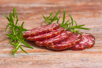 salami slices with pepper and rosemary