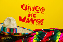 Mexican Serape Blanket And Sombrero On Yellow Background With Cinco De Mayo. 