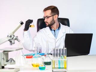 Poster - chemical experiment. research in the field of chemistry. the scientist examines the chemical liquid 