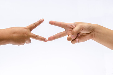 Close up of two hands show scissors hand playing in rock paper scissors game, Isolated on white background, place for text or sign.