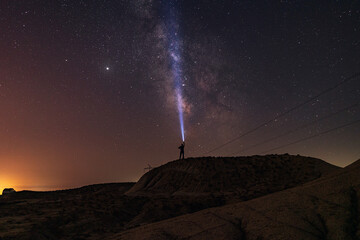 Wall Mural - milky way on night sky and standing man silhouette with flashlight . colorful night landscape. explo