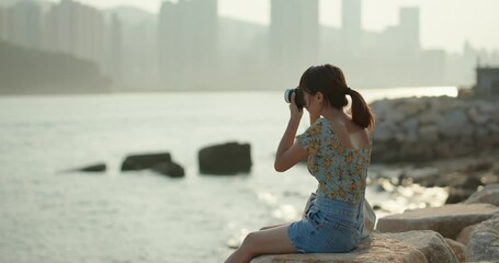 Canvas Print - Woman use of digital camera to take photo at sea view