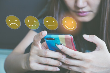 Canvas Print - Customer Experience Concept, happy Business women holding the smartphone with a checked box on Excellent Smiley Face and Rating for a satisfaction survey