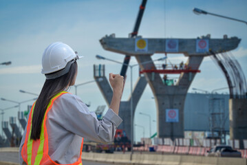 Successful female engineers stood at the background of the expressway being constructed.