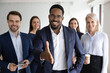 Portrait of smiling African American team leader stretch hand greeting job candidate or applicant in office. Happy multiracial businesspeople meet welcome newcomer at workplace. Employment concept.