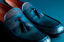 Blue Loafer Shoes On Blue Background. One Pair. Close Up.