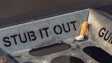 Stub It Out - Close Up Of A Cigarette Stub On A Waste Bin	
