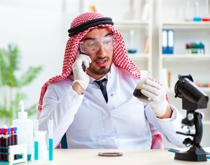 Wall Mural - Arab chemist working in the lab office