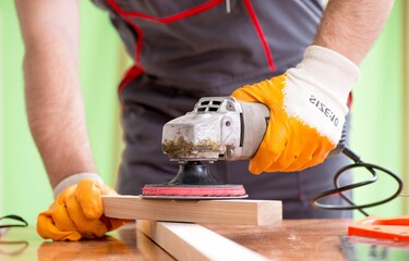 Wall Mural - Young man carpenter working in workshop