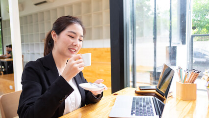 Portrait of female student using mock up digital tablet on wooden table in co working space in library