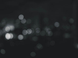 abstract black background with blurry white bokeh at night