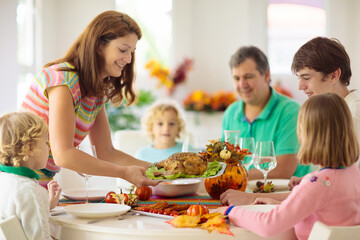 Wall Mural - Family with kids at Thanksgiving dinner. Turkey.