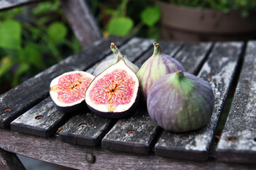 Wall Mural - Fresh figs. Food Photo. whole and sliced figs on rustic background.