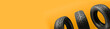 three friction tires, winter season re-booting, on a bright orange background. copy space panorama for the site header