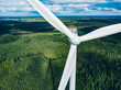 Aerial view of windmill close-up in green summer forest in Finland. Wind turbines for electric power  and Renewable Energy