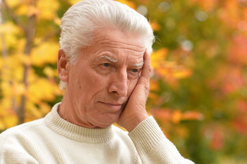 Sticker - Close up portrait of sad senior man in park